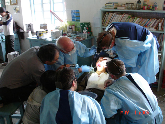 Dr. Stoner demonstrating for Ethan Draken, Mike Lisien, Dan Stoner and Chinese physician